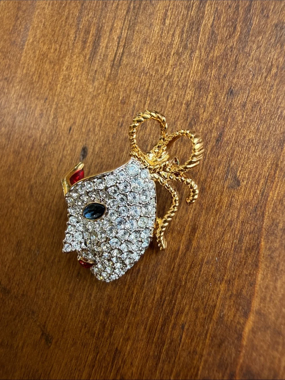 vintage 1990s Swarovski masquerade mask brooch features a pave-set crystal face